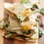 Satisfying Vegan Mushroom and Spinach Quesadillas for Easy Meals 8 Stacked vegan mushroom and spinach quesadillas with melted plant-based cheese