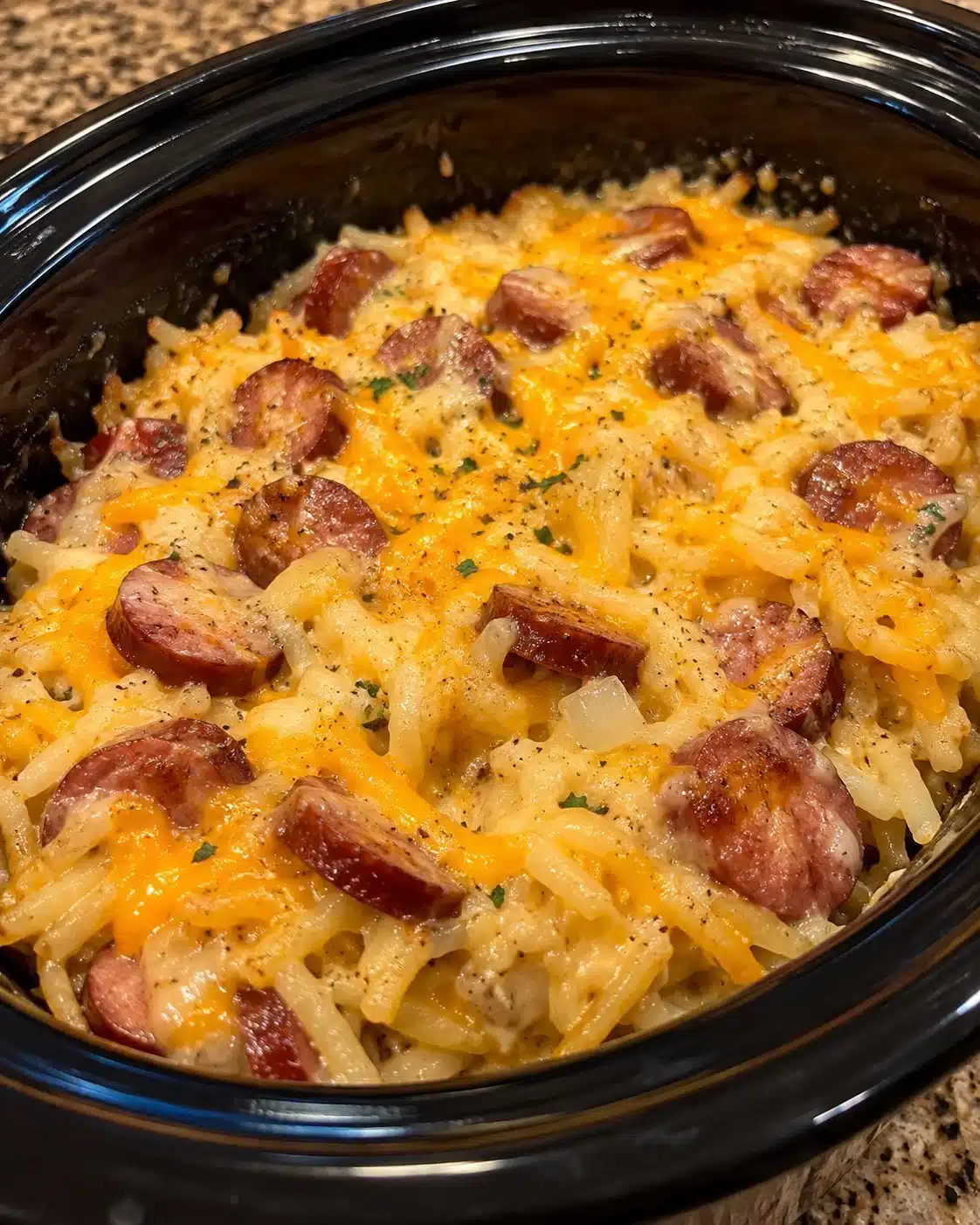 A warm hearty slow cooker casserole loaded with smoky kielbasa, tender hashbrowns, onions, and melted cheddar, all cooked into a rich comforting dish that feels like pure homestyle goodness.